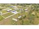 Aerial view of a residential area with various houses, lawns, and a container at 13522 Rockridge Rd, Lakeland, FL 33809