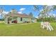 Expansive backyard featuring lush lawn, patio area, and playset at 13522 Rockridge Rd, Lakeland, FL 33809