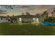 Spacious backyard featuring a covered patio, a pristine lawn, and recreational amenities at 13522 Rockridge Rd, Lakeland, FL 33809