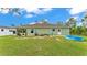 Spacious backyard featuring a covered patio, a pristine lawn, and recreational amenities at 13522 Rockridge Rd, Lakeland, FL 33809