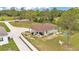 Aerial view of a home with covered patio, a white fence, green lawn and playset at 13522 Rockridge Rd, Lakeland, FL 33809