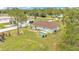A spacious backyard with a light green house, a patio, and a playground at 13522 Rockridge Rd, Lakeland, FL 33809