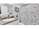 Charming bathroom with a granite countertop, decorative shower curtain, and white vanity at 13522 Rockridge Rd, Lakeland, FL 33809