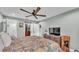 Spacious bedroom featuring a ceiling fan, closet with sliding doors, and ensuite bathroom entrance at 13522 Rockridge Rd, Lakeland, FL 33809