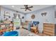 Cozy Bedroom featuring a wooden crib, glider chair, natural light, and decorative accents at 13522 Rockridge Rd, Lakeland, FL 33809