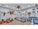 Playful bedroom featuring toys, light blue walls, neutral carpet and a ceiling fan at 13522 Rockridge Rd, Lakeland, FL 33809