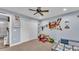 Bright bedroom with neutral carpet, large closet, ceiling fan, and view into the bathroom at 13522 Rockridge Rd, Lakeland, FL 33809