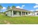 Charming single-story home with a covered front porch and verdant landscaping at 13522 Rockridge Rd, Lakeland, FL 33809
