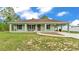 Charming single-story home featuring a welcoming front porch and covered carport at 13522 Rockridge Rd, Lakeland, FL 33809