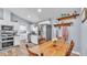 Kitchen features a wooden dining table, shelves, and stainless steel appliances at 13522 Rockridge Rd, Lakeland, FL 33809