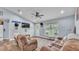 Cozy living room featuring comfortable seating, neutral colors, and wood-look flooring at 13522 Rockridge Rd, Lakeland, FL 33809
