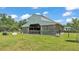 Exterior of horse barn with wood siding and metal roof, with lush green pasture at 1385 Ewell Rd, Lakeland, FL 33811