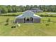 Aerial view of a horse barn with stalls and fenced pasture area at 1385 Ewell Rd, Lakeland, FL 33811