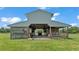 Barn exterior with an open stall, showing concrete flooring and ample space for parking equipment at 1385 Ewell Rd, Lakeland, FL 33811