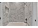 Stylish bathroom with marble tile shower with built-in niche and modern fixtures at 1385 Ewell Rd, Lakeland, FL 33811