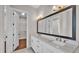 Bathroom featuring a double sink vanity, and a doorway to a walk-in closet at 1385 Ewell Rd, Lakeland, FL 33811