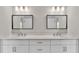 Bright bathroom featuring a double vanity with white cabinets, quartz countertop, and modern rectangular mirrors at 1385 Ewell Rd, Lakeland, FL 33811