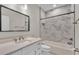 Bathroom showcasing marble tiled shower with built-in niche, and white vanity at 1385 Ewell Rd, Lakeland, FL 33811