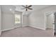 Light-filled bedroom with neutral carpet, a ceiling fan, and a walk-in closet at 1385 Ewell Rd, Lakeland, FL 33811