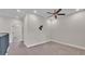 Bright bedroom with carpet flooring, ceiling fan, and gray metal railing at 1385 Ewell Rd, Lakeland, FL 33811