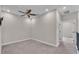 Bright bedroom with carpet flooring, ceiling fan, and gray metal railing at 1385 Ewell Rd, Lakeland, FL 33811