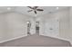 Bright bedroom with carpet flooring, ceiling fan, and two doors at 1385 Ewell Rd, Lakeland, FL 33811