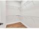 Organized walk-in closet with ample shelving and hardwood floors at 1385 Ewell Rd, Lakeland, FL 33811
