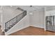 A dining room with hardwood floors, a staircase, and stainless steel refrigerator at 1385 Ewell Rd, Lakeland, FL 33811