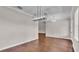 A dining room with hardwood floors and modern light fixtures at 1385 Ewell Rd, Lakeland, FL 33811