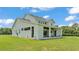 Exterior view of the back of this modern two-story home with a covered patio at 1385 Ewell Rd, Lakeland, FL 33811