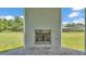 Outdoor fireplace with a metal grate and stucco surround overlooking the home's acreage at 1385 Ewell Rd, Lakeland, FL 33811
