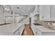 A kitchen with a large island, stainless steel appliances, and a view of the staircase at 1385 Ewell Rd, Lakeland, FL 33811
