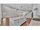 A kitchen with a large island, stainless steel appliances, and a view of the living room at 1385 Ewell Rd, Lakeland, FL 33811