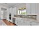 Well-lit kitchen featuring a farmhouse sink, stainless steel appliances, and white cabinetry at 1385 Ewell Rd, Lakeland, FL 33811