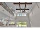 Dramatic living area featuring a high ceiling, exposed beams, and ample natural light at 1385 Ewell Rd, Lakeland, FL 33811