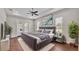 A main bedroom with hardwood floors, a ceiling fan, and french doors leading to the lanai at 1385 Ewell Rd, Lakeland, FL 33811