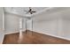 Spacious bedroom with hardwood floors, ceiling fan, and a tray ceiling at 1385 Ewell Rd, Lakeland, FL 33811