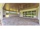 Covered patio with stone pavers, a wood ceiling, an outdoor fireplace, and large sliding glass doors at 1385 Ewell Rd, Lakeland, FL 33811