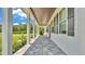 Inviting covered porch with stone flooring and elegant pillars, offering a relaxing outdoor space at 1385 Ewell Rd, Lakeland, FL 33811