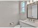 Modern powder room with a sleek vanity, framed mirror, and contemporary fixtures at 1385 Ewell Rd, Lakeland, FL 33811