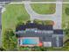 Aerial shot of a house with a pool, stone driveway, lush green lawn and professional landscaping at 1425 Hallam Dr, Lakeland, FL 33813