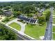 Aerial view of a beautiful home with a pool, manicured lawn, and mature trees at 1425 Hallam Dr, Lakeland, FL 33813