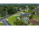 Overhead shot of a charming home with a pool, beautiful landscaping, and mature trees at 1425 Hallam Dr, Lakeland, FL 33813