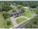 An overhead view showcasing the home with a private pool, a stone driveway, and a lush green lawn at 1425 Hallam Dr, Lakeland, FL 33813