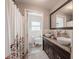 Bathroom with double sinks, granite countertops, and floral shower curtain at 1425 Hallam Dr, Lakeland, FL 33813