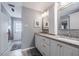 Bright bathroom featuring double sink vanity, granite countertop, framed mirrors and grey walls at 1425 Hallam Dr, Lakeland, FL 33813