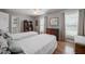 Comfortable bedroom with two beds, ceiling fan, hardwood floors and bright windows at 1425 Hallam Dr, Lakeland, FL 33813