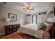 Bedroom featuring hardwood floors, ceiling fan, dresser, bed and lots of storage at 1425 Hallam Dr, Lakeland, FL 33813
