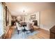 Elegant dining room featuring chandelier, brick fireplace, and adjacent home office with custom bookshelf at 1425 Hallam Dr, Lakeland, FL 33813