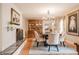 Traditional dining room with a decorative fireplace, chandelier and large wooden china cabinet at 1425 Hallam Dr, Lakeland, FL 33813